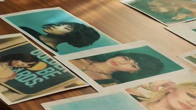 Printed portrait photographs arranged on a wooden surface with teal and yellow color grading.